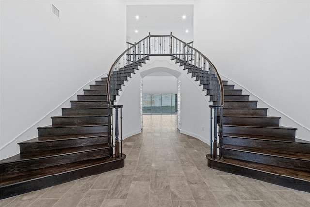 2324 Bel Paese Bnd, Leander, TX 78641 - stairway featuring a high ceiling, arched walkways, and recessed lighting