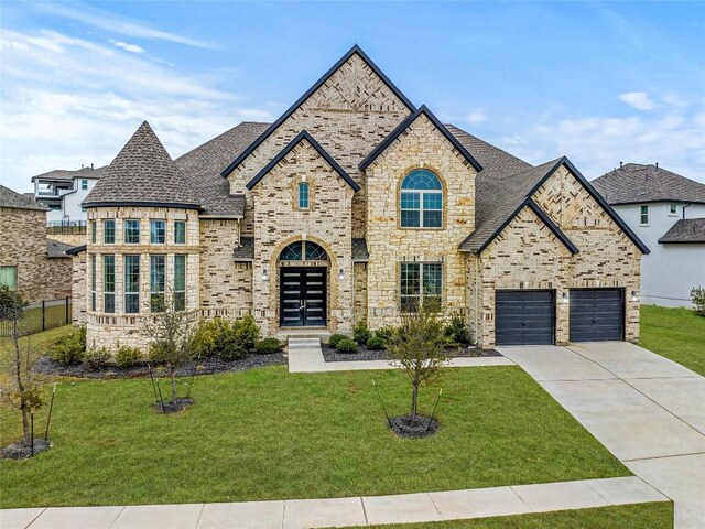 2324 Bel Paese Bnd, Leander, TX 78641 - french provincial home featuring driveway, roof with shingles, brick siding, and stone siding