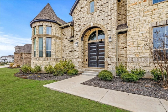 2324 Bel Paese Bnd, Leander, TX 78641 - property entrance featuring a lawn, brick siding, and stone siding