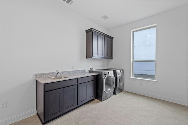 2324 Bel Paese Bnd, Leander, TX 78641 - washroom featuring cabinet space, washing machine and dryer, and light tile patterned floors