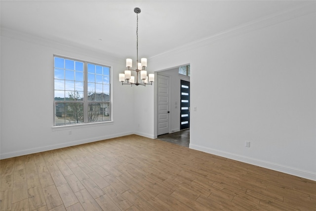 2324 Bel Paese Bnd, Leander, TX 78641 - spare room featuring a chandelier, ornamental molding, and wood finished floors