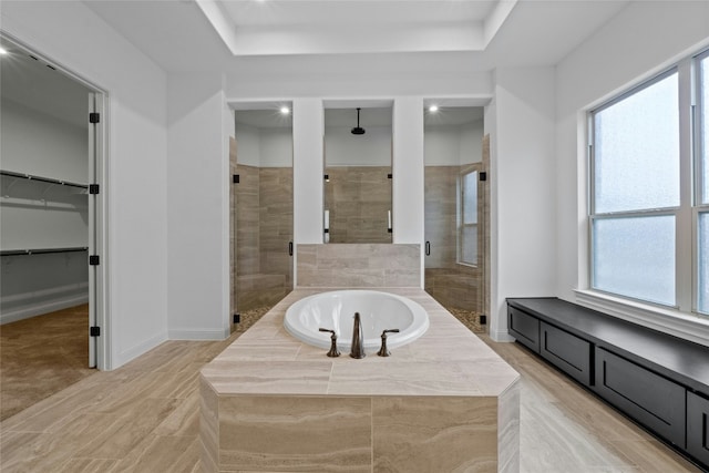 2324 Bel Paese Bnd, Leander, TX 78641 - bathroom with a stall shower, a bath, healthy amount of natural light, a walk in closet, and recessed lighting