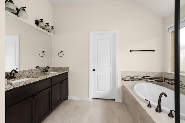 4131 Van Ness Ave, Round Rock, TX 78681 - full bath with lofted ceiling, a bath, double vanity, and baseboards