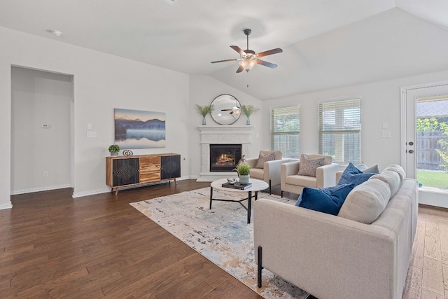 4131 Van Ness Ave, Round Rock, TX 78681 - living room with lofted ceiling, dark wood finished floors, a lit fireplace, and ceiling fan