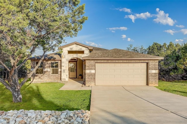 view of front of house featuring a front yard and a garage