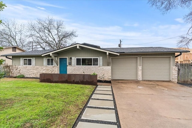 single story home with concrete driveway, stone siding, a garage, and a front yard