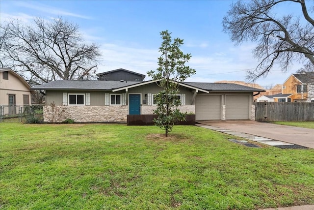 ranch-style home with a garage, fence, concrete driveway, and a front yard