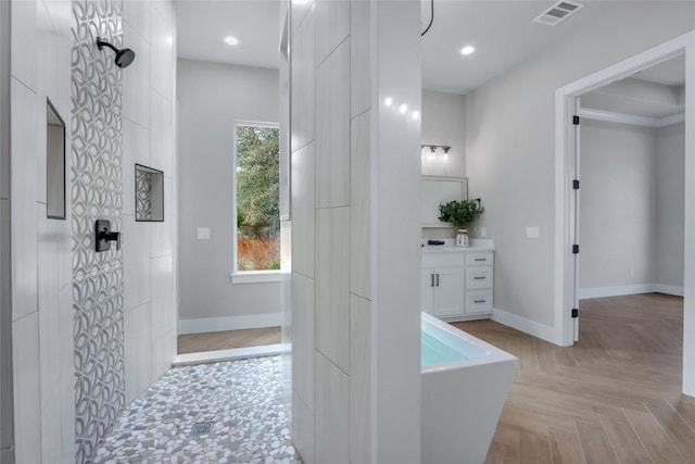 full bathroom featuring baseboards, a soaking tub, visible vents, and walk in shower
