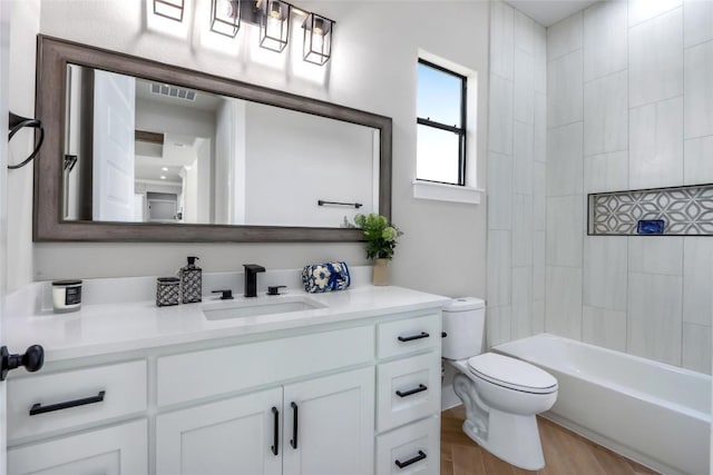 full bath with visible vents, toilet, vanity, wood finished floors, and  shower combination
