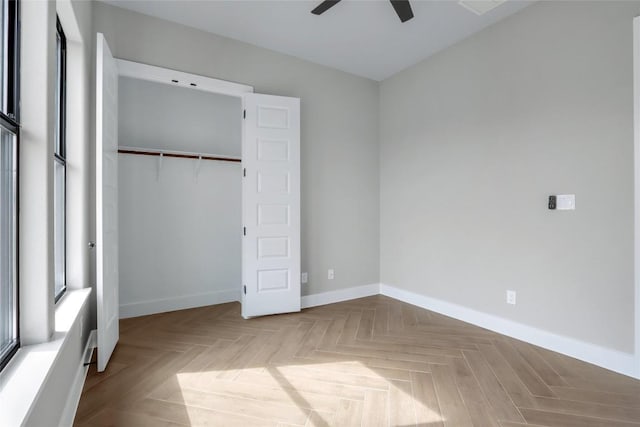 unfurnished bedroom featuring baseboards, a ceiling fan, and a closet