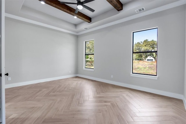 empty room featuring baseboards, visible vents, ceiling fan, and beam ceiling