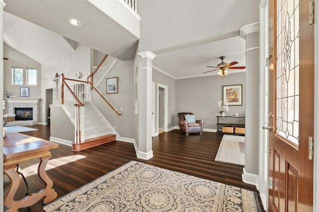 entryway with baseboards, stairs, wood finished floors, and ornate columns