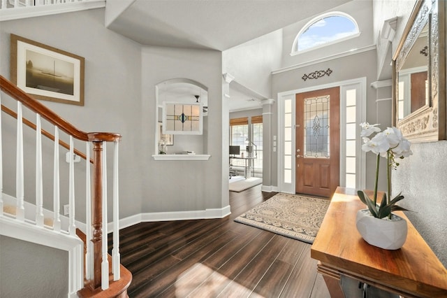 entrance foyer with baseboards, dark wood-style floors, stairs, and plenty of natural light