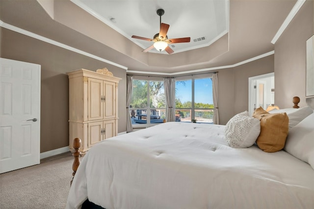 bedroom featuring crown molding, baseboards, a raised ceiling, visible vents, and light colored carpet