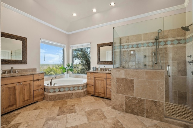 bathroom featuring crown molding, a bath, a sink, and two vanities