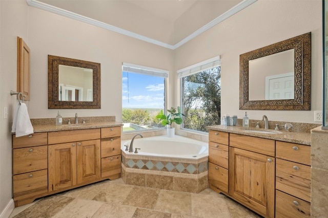 full bathroom featuring a sink, two vanities, a bath, and crown molding