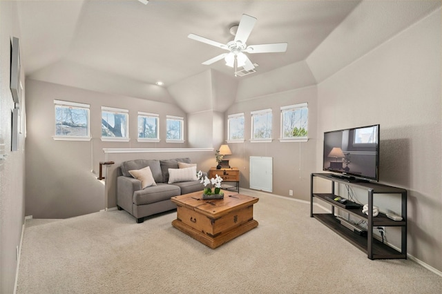 living area featuring a wealth of natural light, visible vents, and light colored carpet