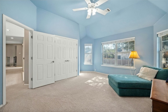 living area featuring ceiling fan, visible vents, baseboards, light carpet, and lofted ceiling