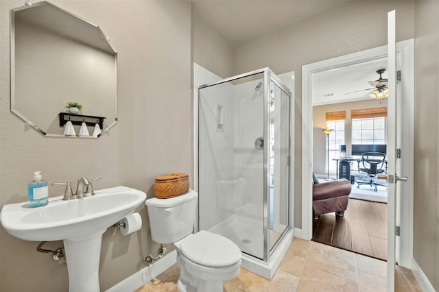 bathroom with baseboards, a ceiling fan, toilet, and a shower stall