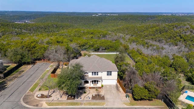 bird's eye view with a wooded view