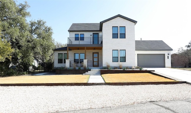 view of front facade with driveway, a shingled roof, an attached garage, and a balcony