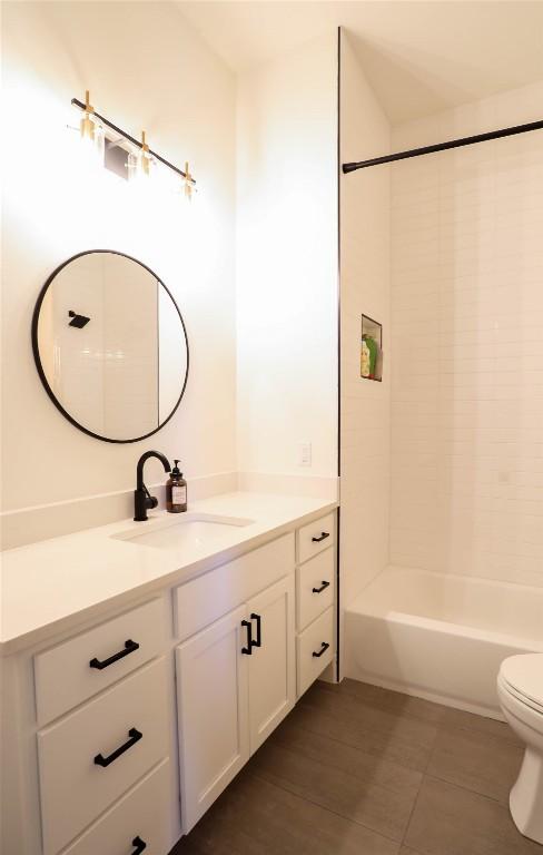 full bathroom with vanity, toilet, and shower / bathtub combination