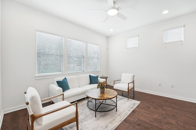 living area featuring dark wood-type flooring, a wealth of natural light, and baseboards