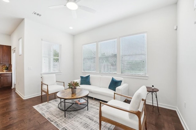 living room featuring ceiling fan, recessed lighting, visible vents, baseboards, and dark wood finished floors