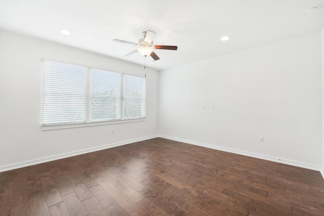 spare room featuring a ceiling fan, baseboards, dark wood-type flooring, and recessed lighting