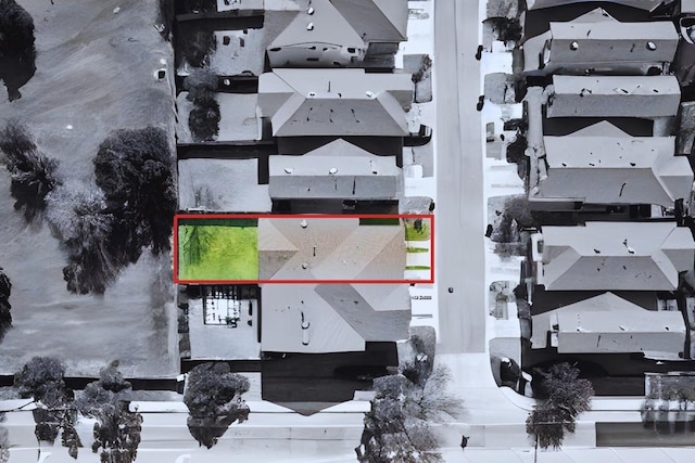 snowy aerial view with a residential view