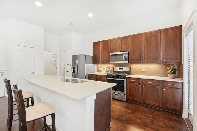 kitchen with a sink, stainless steel appliances, and light countertops