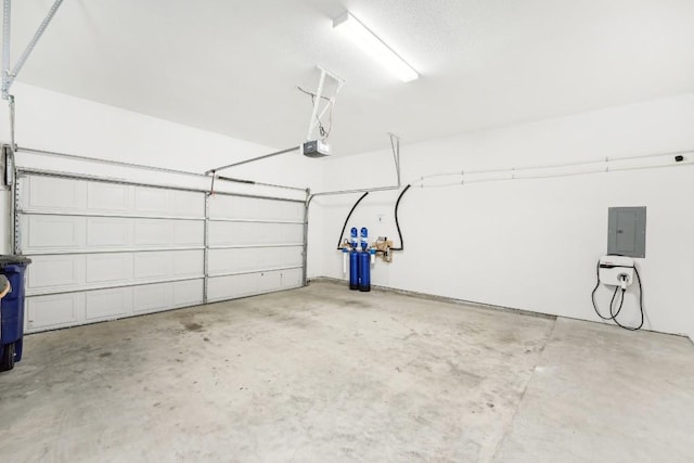 garage with a garage door opener and electric panel