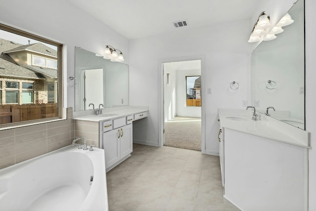 full bathroom featuring two vanities, visible vents, and a sink