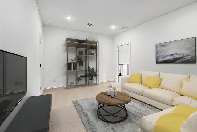 living room featuring baseboards, visible vents, and recessed lighting