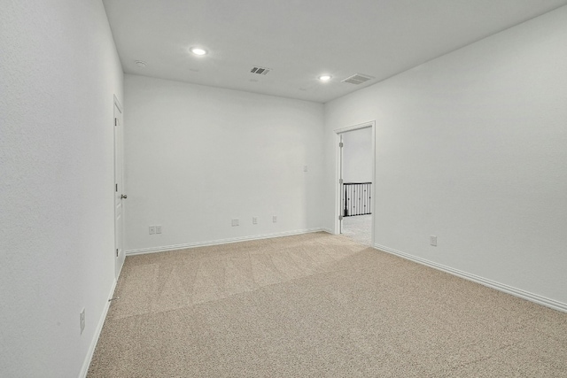 unfurnished room featuring light carpet, baseboards, visible vents, and recessed lighting