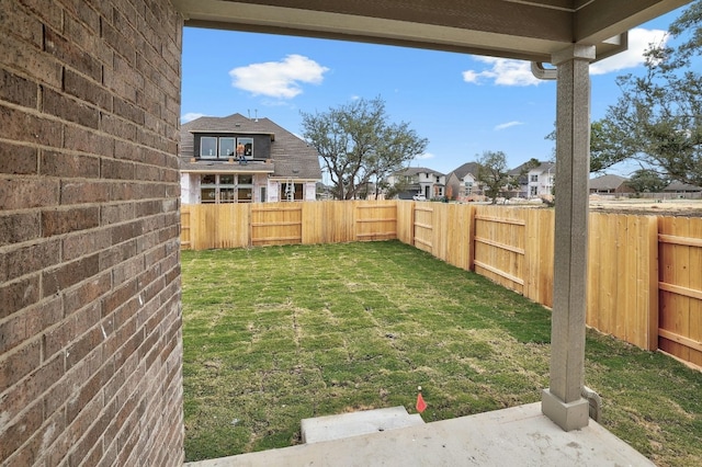 view of yard featuring a residential view and a fenced backyard