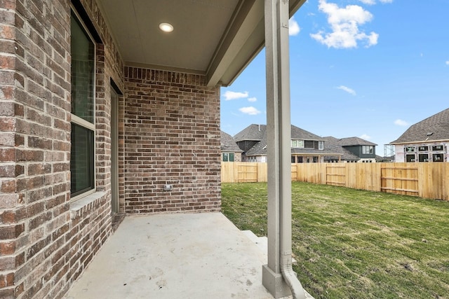 view of patio / terrace with fence and a residential view