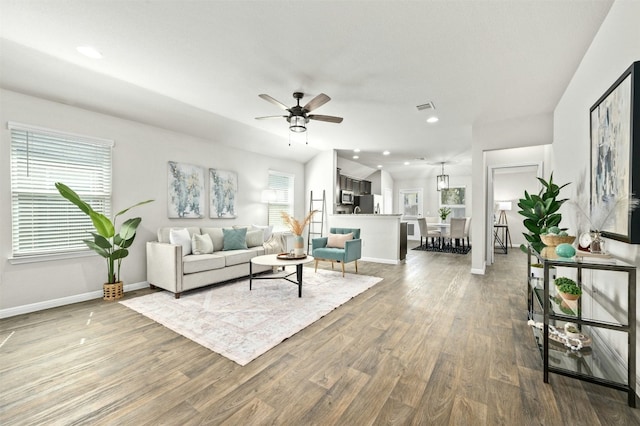 living area featuring ceiling fan, recessed lighting, wood finished floors, visible vents, and baseboards