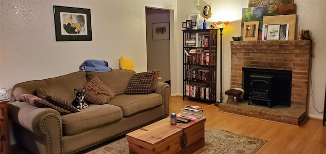 living area featuring wood finished floors and a fireplace