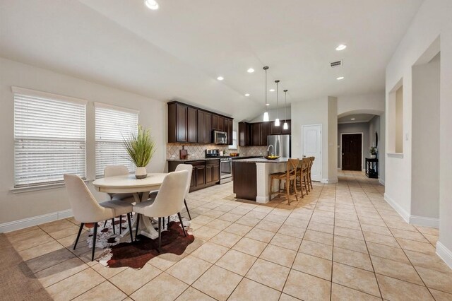 3541 Guadalajara St, Round Rock, TX 78665 - dining area featuring arched walkways, vaulted ceiling, recessed lighting, and light tile patterned floors