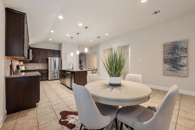 3541 Guadalajara St, Round Rock, TX 78665 - dining area with vaulted ceiling, light tile patterned floors, arched walkways, and recessed lighting