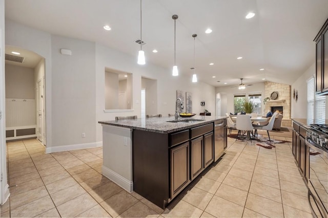 3541 Guadalajara St, Round Rock, TX 78665 - kitchen featuring appliances with stainless steel finishes, ceiling fan, light tile patterned flooring, light stone countertops, and open floor plan