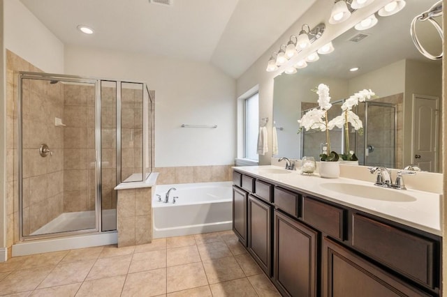 3541 Guadalajara St, Round Rock, TX 78665 - bathroom with tile patterned flooring, a garden tub, double vanity, a stall shower, and lofted ceiling