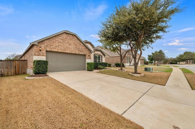 ranch-style home with concrete driveway, an attached garage, fence, a front lawn, and brick siding