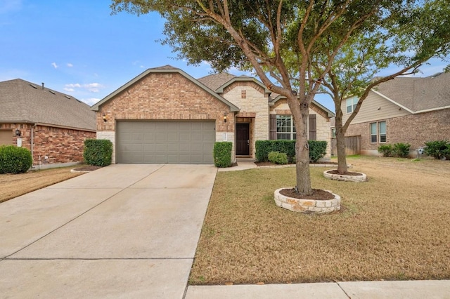 3541 Guadalajara St, Round Rock, TX 78665 - traditional-style home featuring a garage, a front lawn, concrete driveway, and brick siding