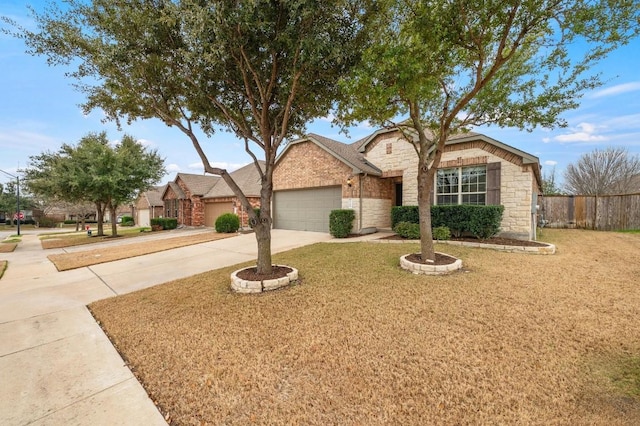3541 Guadalajara St, Round Rock, TX 78665 - view of front of house with stone siding, an attached garage, and concrete driveway