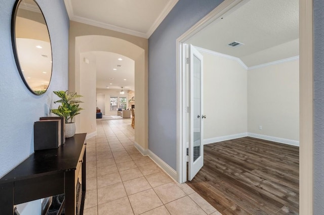 3541 Guadalajara St, Round Rock, TX 78665 - hallway featuring arched walkways, crown molding, and light wood finished floors