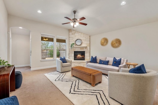 3541 Guadalajara St, Round Rock, TX 78665 - living room with a ceiling fan, vaulted ceiling, carpet flooring, a stone fireplace, and arched walkways