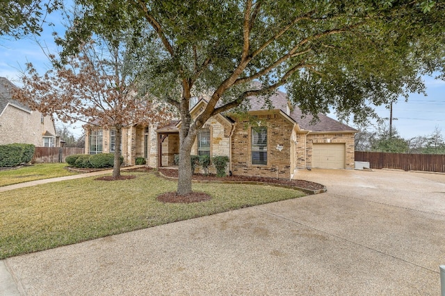 view of front of house with an attached garage, fence, concrete driveway, and brick siding