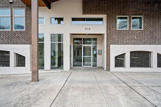 property entrance with stucco siding